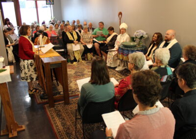 Clergy member speaking at the lectern to the congregation