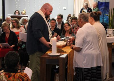Clergy sharing Holy Communion with the congregation at Trinity Place