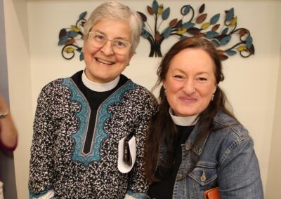 Two clergywomen posing together, smiling